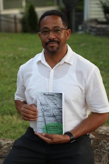 Rahim Buford holding his book