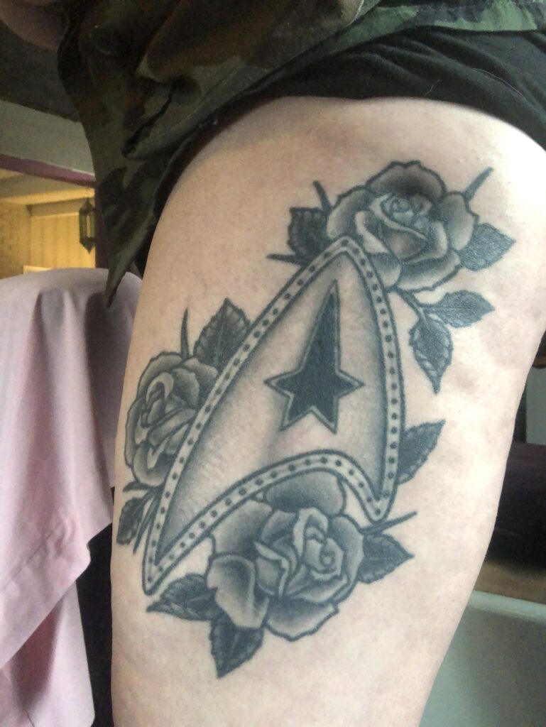 Brianne's Star Trek Delta Tattoo adorned with Roses