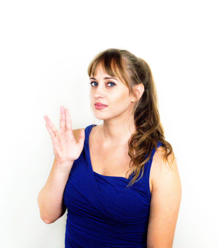 Headshot of Stephanie Gerk giving the Vulcan Salute